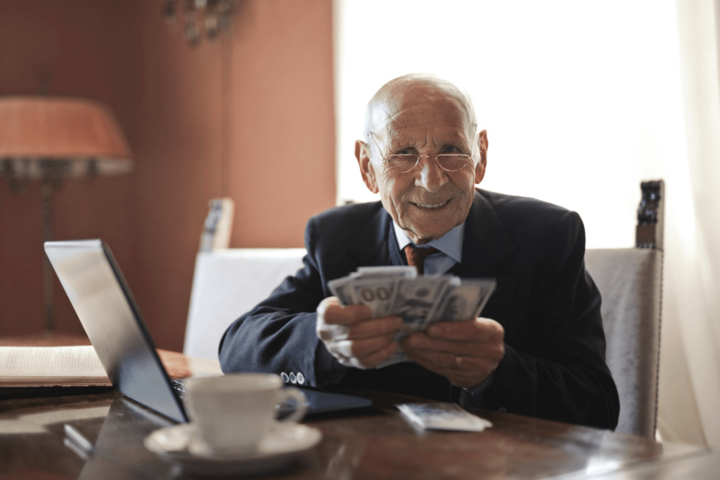 elderly man counts the money