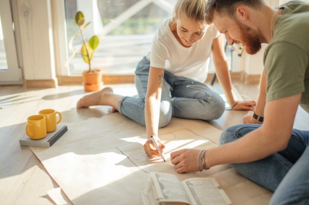 couple looking blueprints of they new house