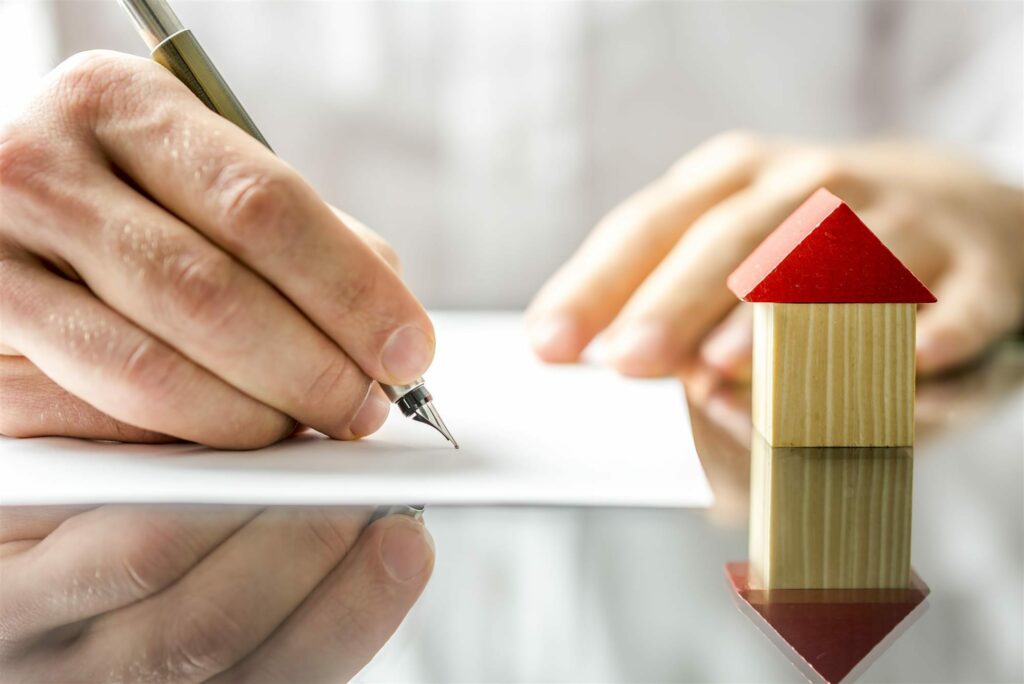 Man Signing A Mortgage Or Insurance Contract