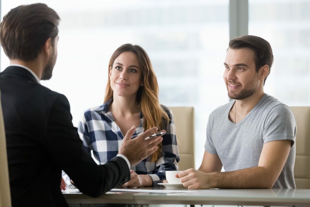 Couple customers consulting financial advisor making presentation offer