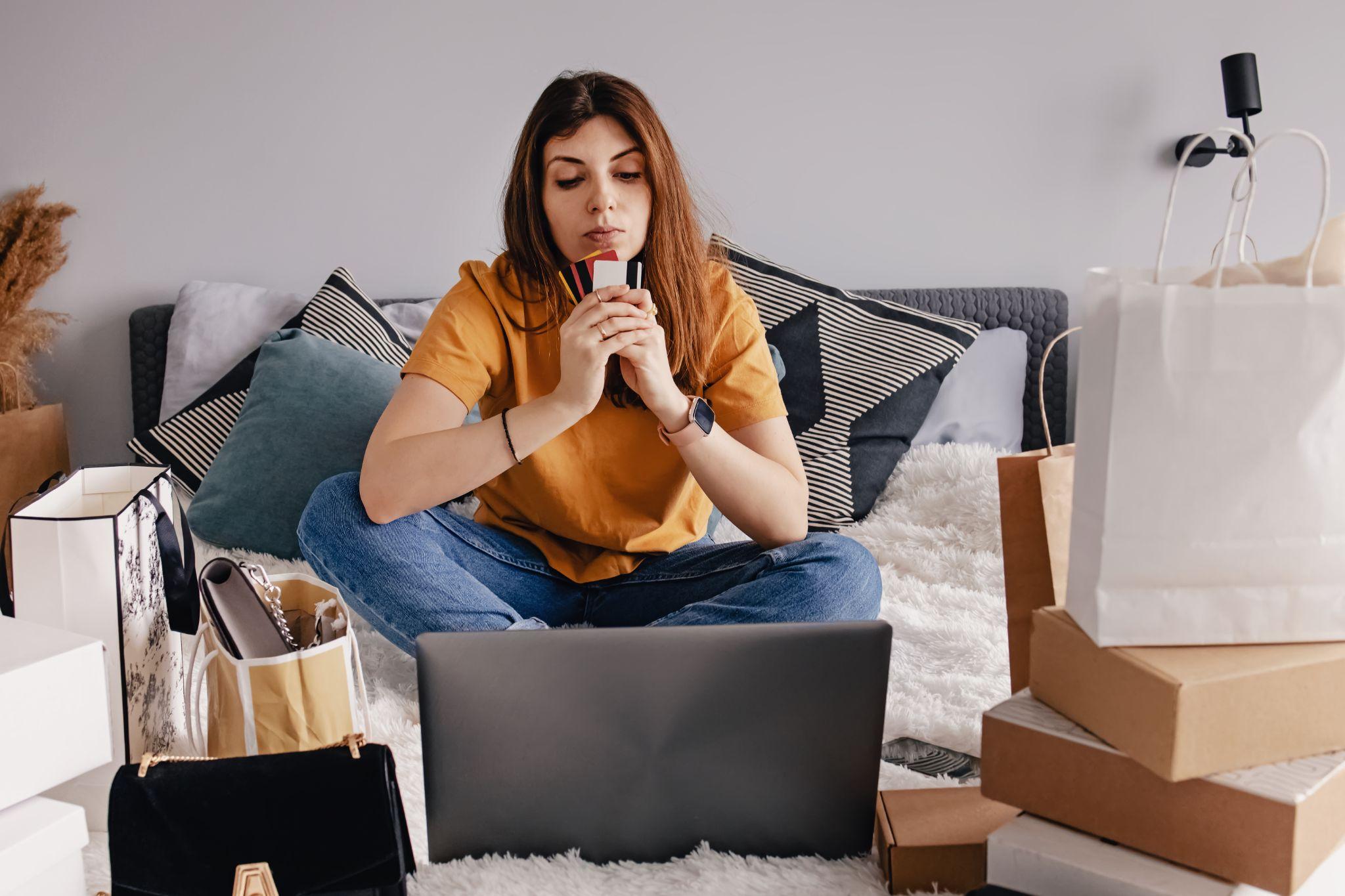 Woman shopping online using her laptop at home