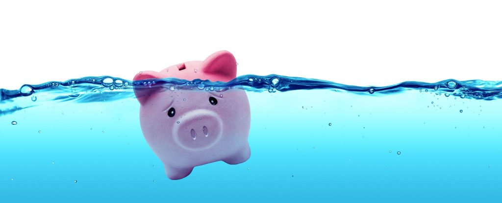 piggy bank drowning in debt