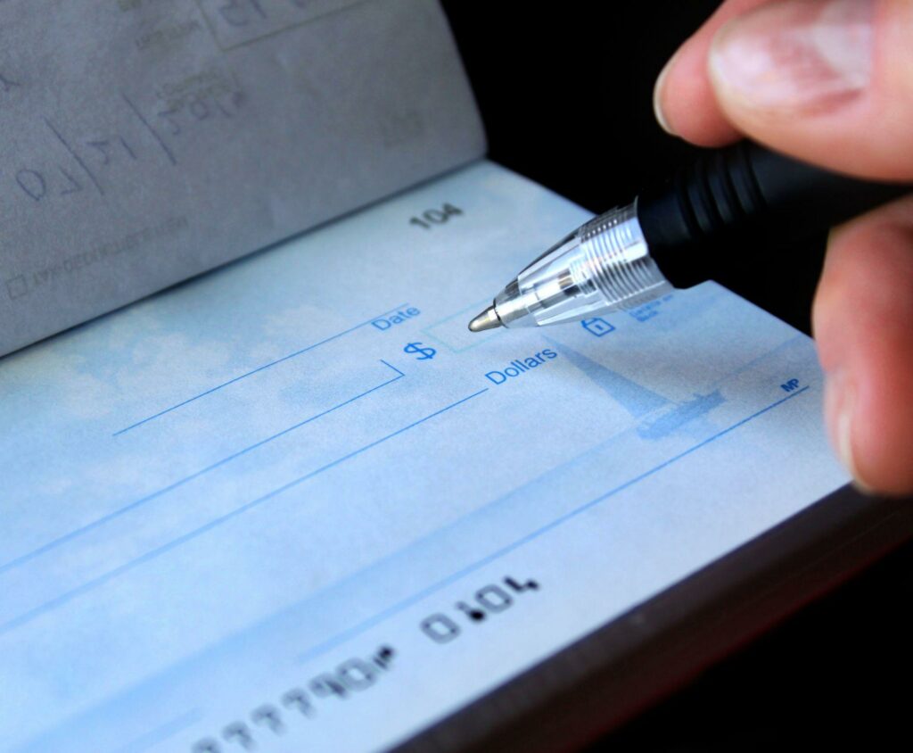 woman signing a check