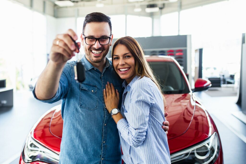 young couple with new car purchase