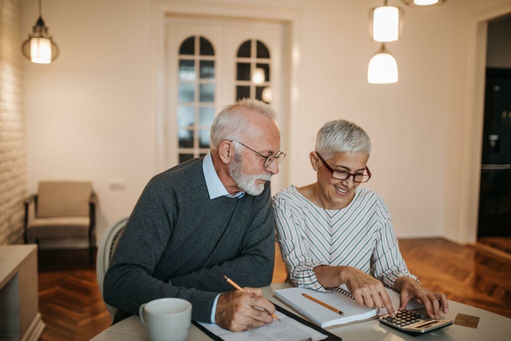 elderly couple calculating retirement savings