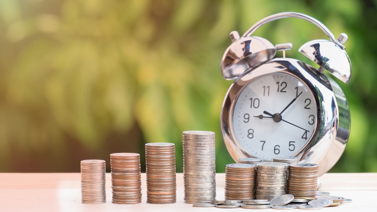 Close up of time and money with green bokeh background