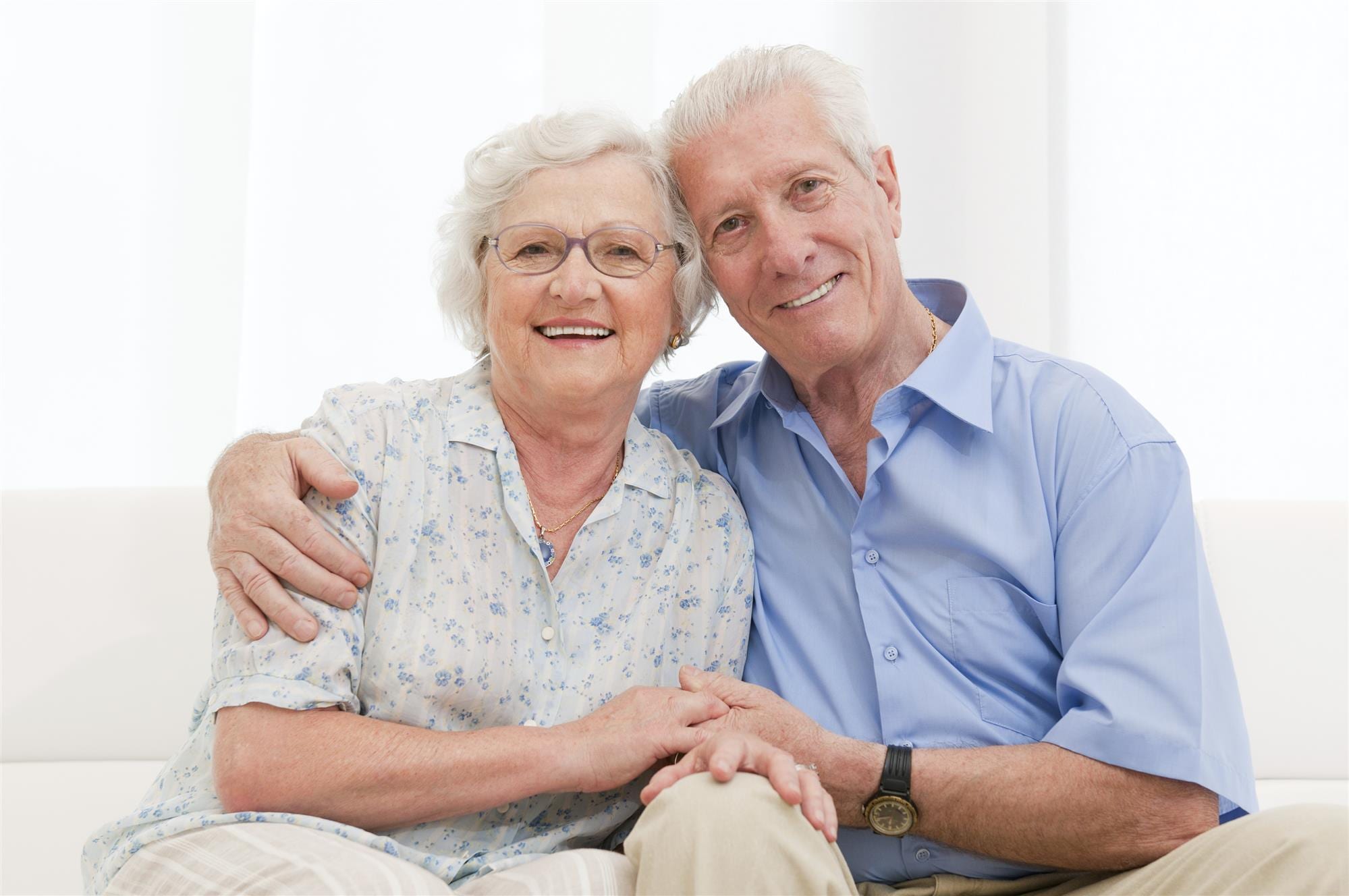 Elderly couple sitting on a couch