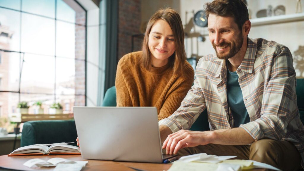 Happy Couple Using Laptop Computer