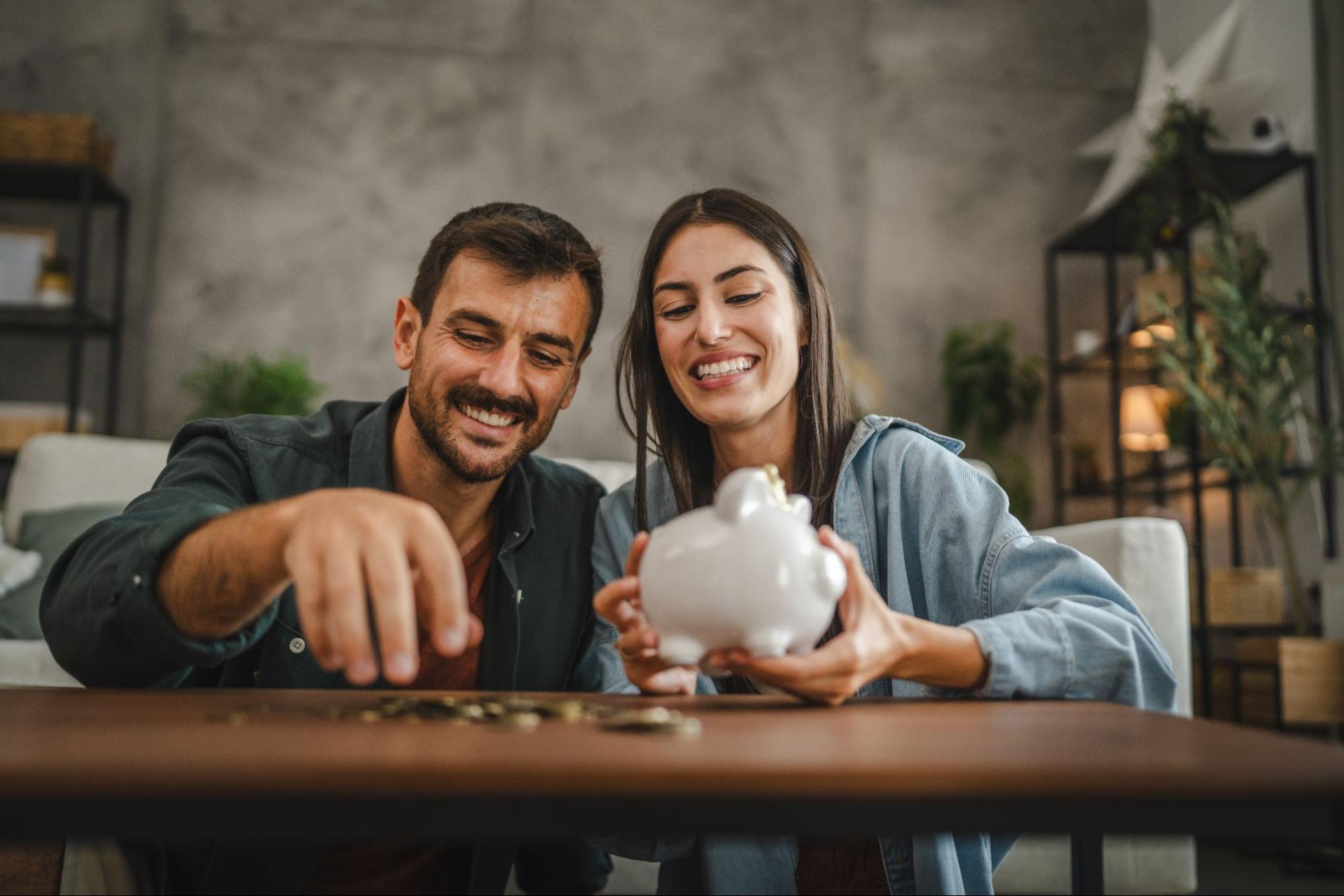 A couple counting coins from their piggy bank