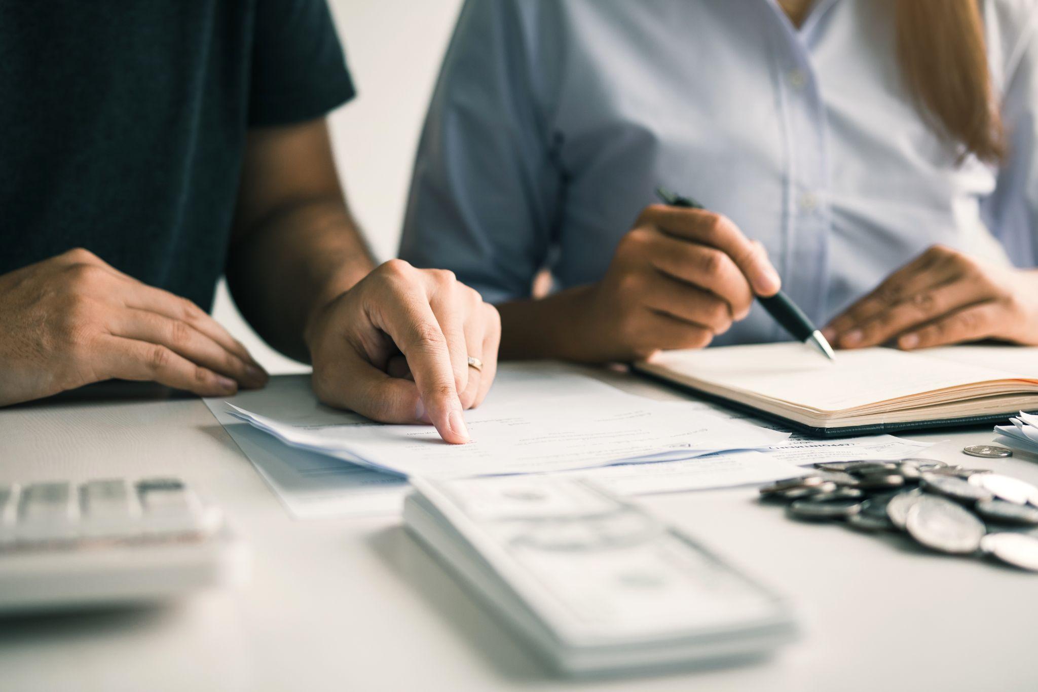 Two couples are together analyzing expenses or finances in deposit accounts and daily income