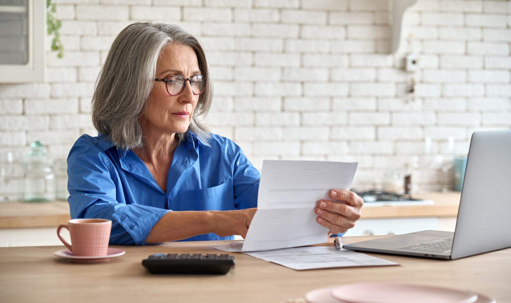 Woman checking IRA CD account paperwork