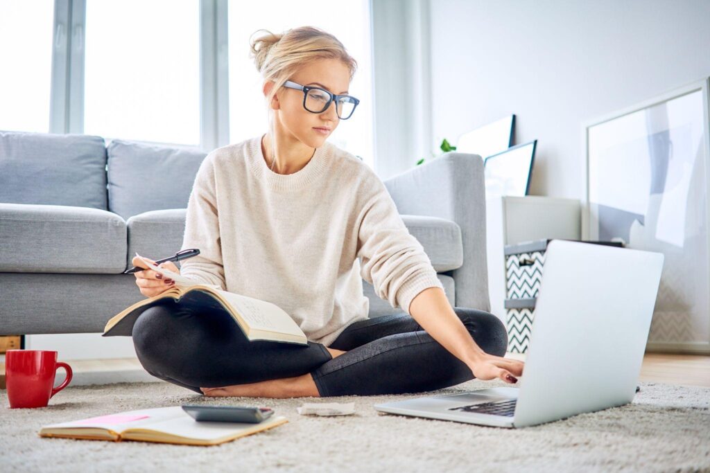 Woman doing the math on how much she should saving for a house on her laptop