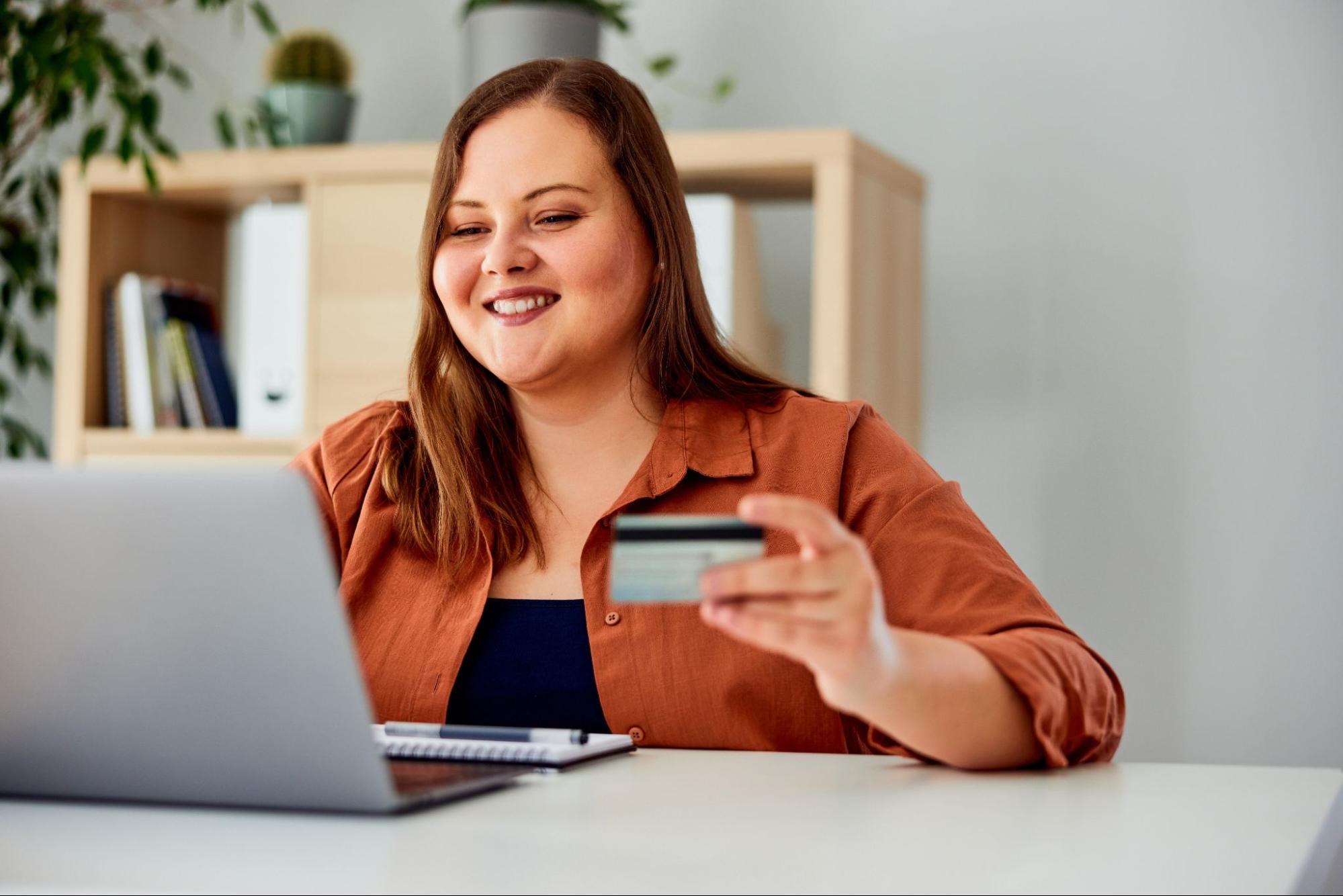 A woman buying something online with a debt card